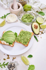 avocado and cream cheese toasts on a plate and ingredients