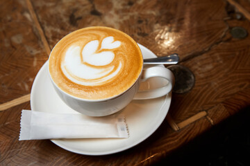 A cup of coffee or Latte with heart pattern in a white cup