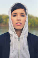 Portrait of young woman outdoors wearing hoodie 