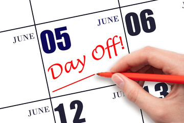 5th day of June. Hand writing text DAY OFF and drawing a line on calendar date 5 June. Vacation...
