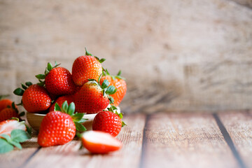 Fresh strawberries on wooden table.