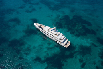 Yachts for a millionaire on the water top view. Aerial view White big yacht is anchored on...