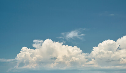 Blue cloudy sky over the sea, background for screensaver or wallpaper on the screen or advertising, free space for text.