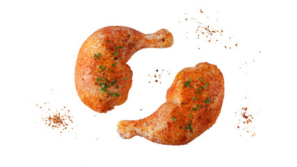 Marinated in tomato sauce with pepper and herbs two raw chicken legs flying isolated on white...