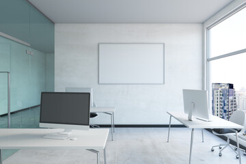 Modern concrete coworking office interior with empty computer screen and mock up poster on wall, window with city view and daylight. 3D Rendering.