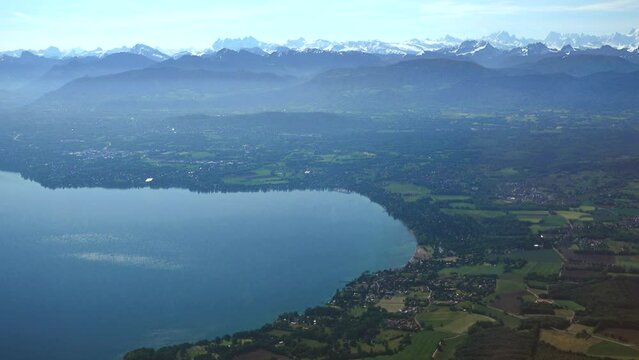 French coast of Geneva (Leman) lake with Excenevex and then countryside and the Alps in the background, aerial view