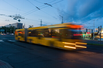 Blurred bus movement along the avenue in the evening.