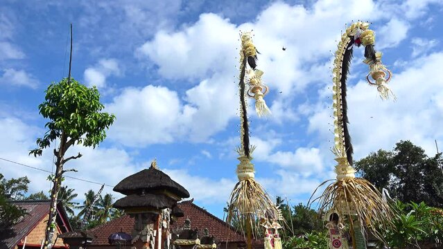 Bamboo pole decorated with coconut leafs and offerings at the end (Penjor), put for the main balinese ceremonies