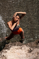 Artistic portrait of a pretty Caucasian woman in swimwear sunbathing on the beach