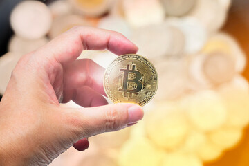 Hand hold glowing bitcoin on blur background