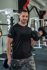Fototapeta na wymiar caucasian man doing workout with dumbbells in gym