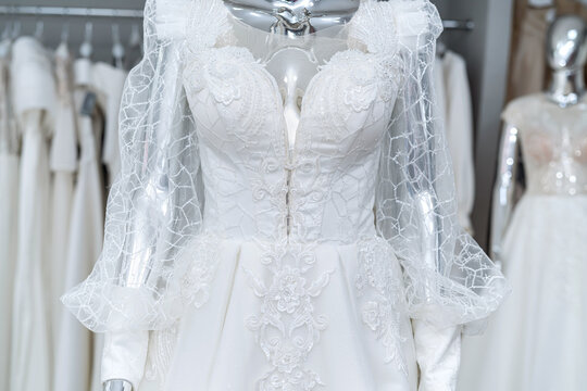 white wedding dress on mannequin in trendy bridal show room