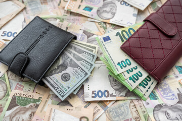 Money 100 dollars and  100 euros in wallet vs 500 1000 ukrainian hryvnia. exchange concept