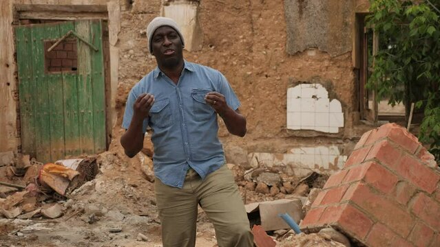 Adult African-american man standing in ruins. High quality 4k footage