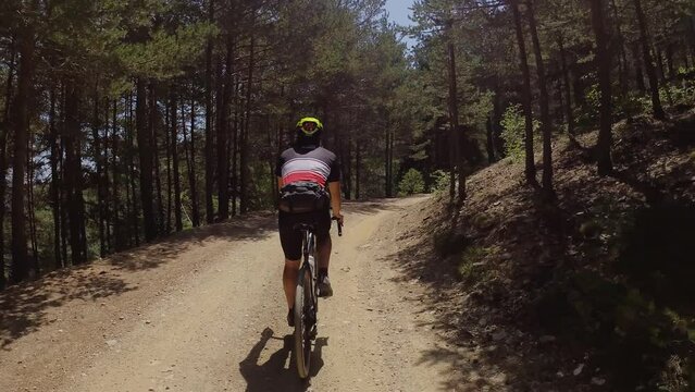 Cyclist male pedaling a gravel bike down the mountain. cycling, gravel