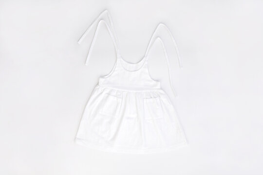 Mockup of white baby cotton dress on white background. Layout mock up ready for your design preview. 