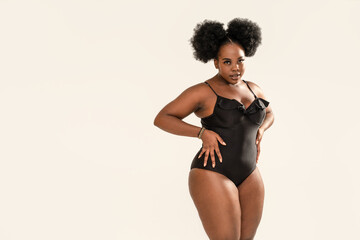 Portrait of beautiful woman wearing black fashionable swimwear. Body positive, conscious concept....