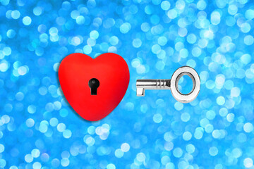Heart shape with a keyhole and a key on blue