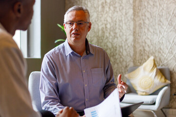 Male professionals discussing business strategies in office