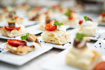 pieces of Italian focaccia with anchovies on a wedding banquet