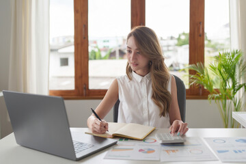 Asian business woman on a video call by laptop. Online meeting concept