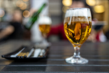 Two glasses of beer over the sidewalk table