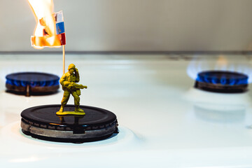 Russian soldier holds a burning flag. Gas issue and economics. Russia is losing