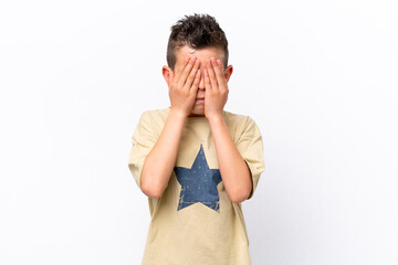 Little caucasian boy isolated on white background covering eyes by hands