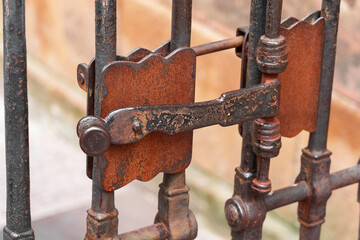 Ancient metal rusty wrought handle deadbolt (latch) of closed door