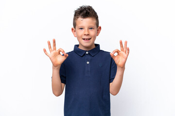 Little caucasian boy isolated on white background showing ok sign with two hands