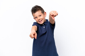 Little caucasian boy isolated on white background pointing front with happy expression