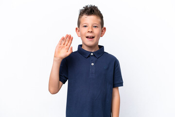 Little caucasian boy isolated on white background saluting with hand with happy expression