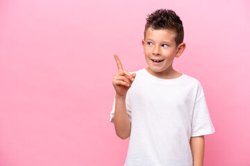 Little caucasian boy isolated on pink background intending to realizes the solution while lifting a finger up - obrazy, fototapety, plakaty