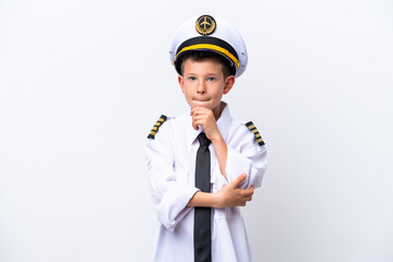 Little airplane pilot boy isolated on white background having doubts and thinking