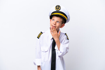 Little airplane pilot boy isolated on white background looking up while smiling