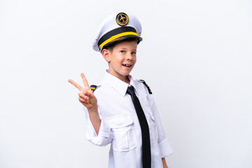Little airplane pilot boy isolated on white background smiling and showing victory sign © luismolinero