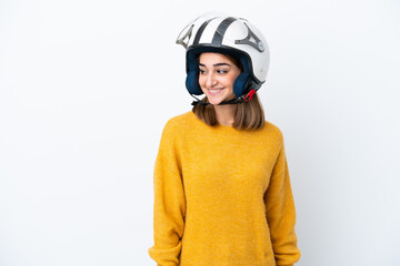 Young caucasian woman with a motorcycle helmet isolated on white background looking to the side and smiling