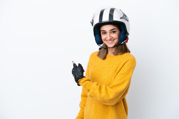 Young caucasian woman with a motorcycle helmet isolated on white background pointing back