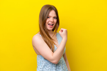 Obraz premium Young caucasian woman isolated on yellow background celebrating a victory
