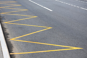 yellow road markings on the road at public transport stops