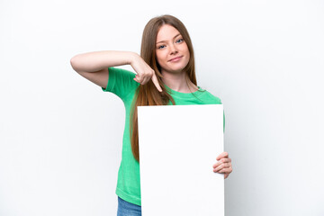 Young caucasian woman isolated on white background holding an empty placard with happy expression and pointing it