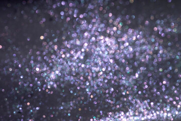 Dark violet background with sequins. Defocused purple glitter background for lettering and postcards.