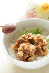 Fried chicken and lettuce on rice for Asian lunch meal image