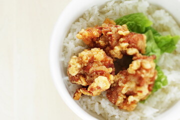 Fried chicken and lettuce on rice for Asian lunch meal image
