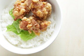 Fried chicken and lettuce on rice for Asian lunch meal image