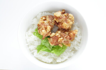 Fried chicken and lettuce on rice for Asian lunch meal image