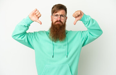 Young reddish caucasian man isolated on white background showing thumb down with two hands