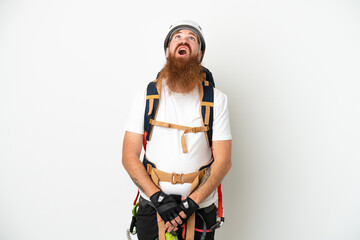 Fototapeta na wymiar Young rock- climber reddish caucasian man isolated on white background looking up and with surprised expression