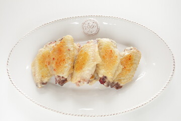 Chinese food, pan fried chicken wings on plate 