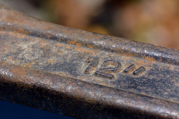 Closeup part of rusty adjustable wrench on natural light background.